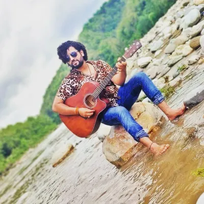 A moment captured with my guitar by the river, a place where I often find musical ideas. As your coach, I will help you develop not just your voice, but also your identity as an artist.