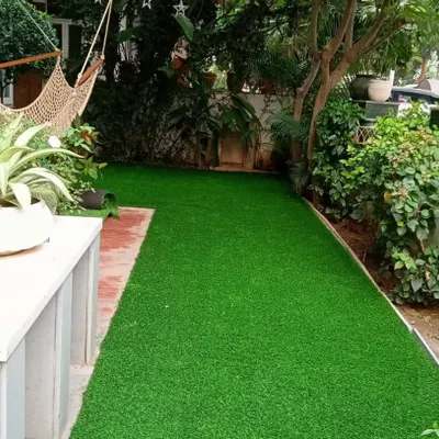 We transformed this residential backyard with a complete artificial turf installation. The result is a clean, usable green space perfect for relaxing in a hammock, surrounded by natural plants.