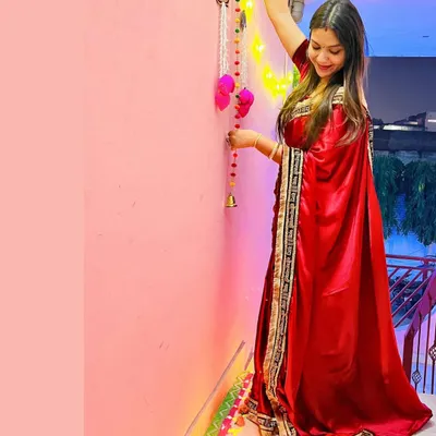 A full-length look at my self-designed red satin Diwali saree. I added a custom border with the "सदा सौभागयवती भव:" embroidery to a plain fabric to create this festive piece.