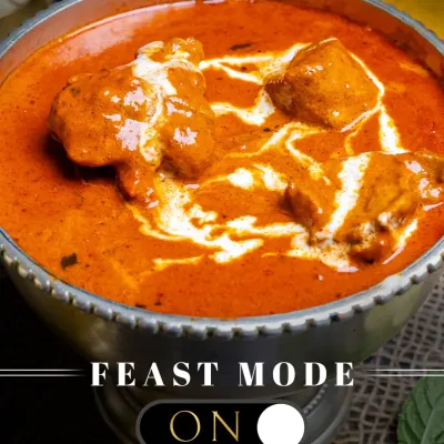 Feast Mode: ON. This is our iconic Butter Chicken, with tender chicken pieces swimming in a velvety, orange-hued tomato and cream gravy. It's the ultimate comfort food.