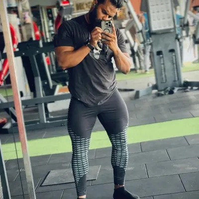 You cannot skip leg day if you want to be a champion. This client is showing his impressive quadriceps development after a grueling leg workout. A balanced physique is key.