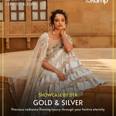 This image is from our 'Gold & Silver' showcase in Mumbai. It features a model in a stunning silver ruffled saree, highlighting the precious and radiant luxury pieces available during our exclusive store events.