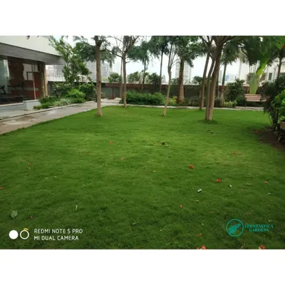 A wide view of a podium garden lawn we maintain. A key part of our service is regular, professional lawn mowing and care to create a vast, uniform carpet of green that serves as the heart of the landscape.
