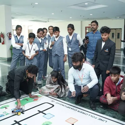 Students and mentors gather around a line-follower course at the Robotics Championship at IIT Delhi, a culmination of months of hard work and preparation.