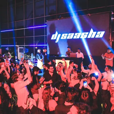 This is the moment I live for. Seeing a sea of hands in the air at a packed rooftop venue, with my name on the big screen, is a feeling like no other. This is the energy I bring to every DJ set.