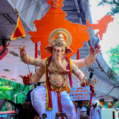 This is one of my proudest creations, a grand Ganpati idol for a public festival. The procession shows the scale of the celebration and the central role the murti plays, standing tall with a backdrop of Bharat, surrounded by devotees.