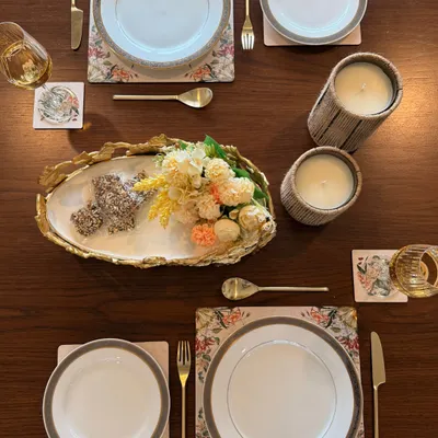 We styled this intimate table for two to turn a simple meal into a shared memory. The setting features our floral placemats, marble coasters, and a gold-leafed serving platter, proving that hosting is in the little moments too.