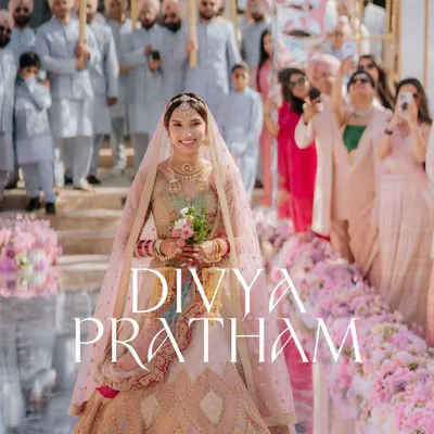 The bride's grand entrance. I captured this moment on a mirrored aisle, surrounded by family and a sea of pink flowers, creating a truly breathtaking photograph.