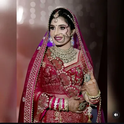 A stunning bride on her wedding day. Her smile and the way her mehndi complements her jewelry and outfit is everything!