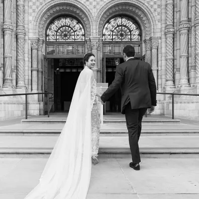 A grand entrance into a new life together. This shot captures the couple's descent into their magnificent reception at the Natural History Museum in London.
