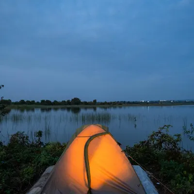 Your personal escape awaits. Imagine waking up in a cozy, lit tent right by the serene waters of a lake. This is our luxury lakeside camping experience, a perfect way to disconnect and recharge.