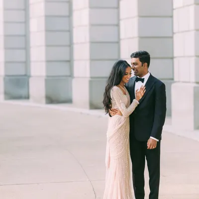 The perfect modern couple look for a party. Nisha is elegant in a shimmering Falguni Shane Peacock sari, and Vishal is sharp in a classic tuxedo from Amaare. They are ready for their grand entrance.