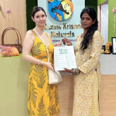 It's wonderful to see customers from all over the world visiting my store. Here, I am happy to be handing over a bag of our natural products to a happy international customer.