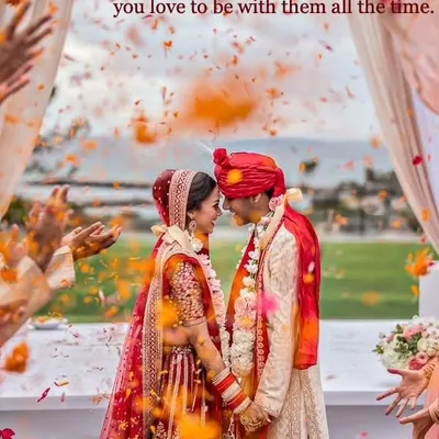 A happy couple shares a loving glance during their wedding ceremony, surrounded by a shower of orange petals. We focus on finding matches where this deep connection and happiness are evident from day one.