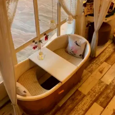 Here is a clear view of our unique bathtub seating by the window. It's a bright and airy spot during the day, perfect for enjoying a leisurely lunch or coffee.