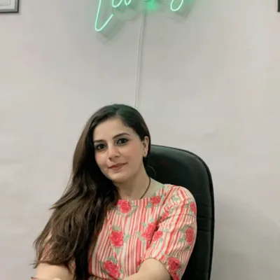 A professional headshot of me at my desk in the "Healthy Living" clinic. This is where I meet clients to create personalized nutrition plans that fit their lifestyle and health goals.