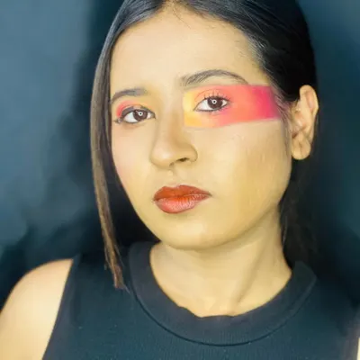 A sunset-inspired abstract eye look created using a color tapping technique. I blended shades of orange, yellow, and red in a bold, graphic block across the eye area for a painterly, high-fashion result.