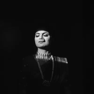 I love playing with light. For this bridal portrait of Kinjal, I used a sliver of morning sunlight coming through a window to create this dramatic, high contrast black and white image. It’s simple, powerful, and all about her serene expression.