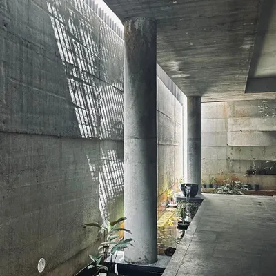 A study in how a narrow sliver of overhead light can animate a simple concrete corridor. The light reflects off the water channel below, creating a dynamic and ever-changing environment that engages the senses.