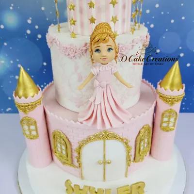 A close-up of the magnificent four-tier princess castle cake for Skylar's 3rd birthday. The design features intricate gold details, pink turrets, and a beautiful princess figurine.