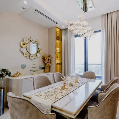 This luxurious dining area is perfect for hosting. The stunning floral chandelier, gold-accented mirror, and plush velvet chairs create an atmosphere of pure elegance. Every meal here feels like a celebration.