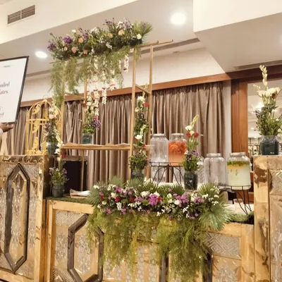 My detox water station is a beautiful addition to any event, featuring glass dispensers with fresh fruits and herbs, and decorated with lush greenery.