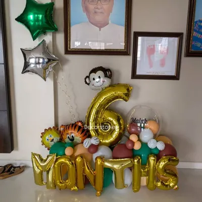 Celebrating a half-birthday with a custom 6-months balloon bouquet. This arrangement features foil numbers and letters, along with cute animal foils, perfect for a milestone photoshoot.
