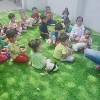 Our Summer Fun Fest is all about joy and discovery. Here, children are gathered for a group activity, sharing stories and making friends in a relaxed, happy atmosphere.