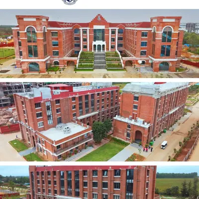 A clear, wide-angle aerial shot of the Harrow International School main building, showcasing its classic brick architecture and grand entrance.