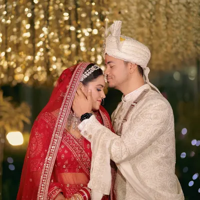 A tender moment between the bride and groom against a backdrop of sparkling lights. I love capturing these quiet, heartfelt interactions that showcase the deep connection you share on your wedding day.