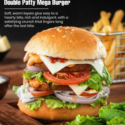 Our Double Patty Mega Burger is pure comfort food. It features two juicy veg patties, crisp lettuce, ripe tomatoes, onions, and cheese, making it a satisfying meal for any time of day.