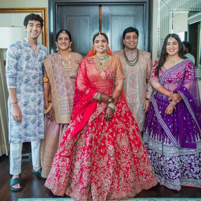 A beautiful portrait of the bride with her entire family. I worked with each person to create a look that reflected their personal style while coordinating with the bride's magnificent red lehenga. The result is a harmonious and elegant family picture.