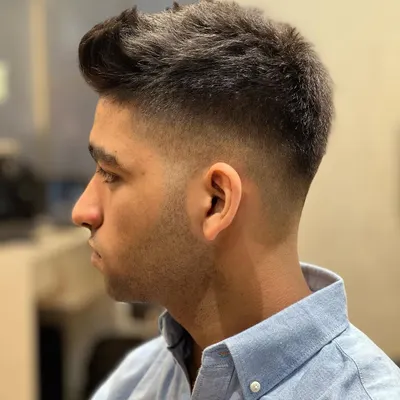 A crisp, sharp skin fade. This is a clean and modern look that requires precision and skill to execute perfectly.