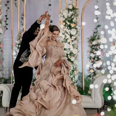 A magical first dance under a sky of sparklers. We use creative lighting and angles to make your reception moments, like this dance in a stunning Gaurav Gupta gown, look truly cinematic.