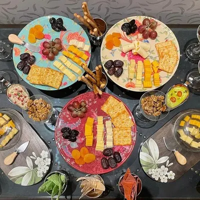 A vibrant and abundant European-style grazing platter. These are perfect for cocktail hours, featuring an assortment of artisanal cheeses, cured meats, fresh fruits, crackers, and nuts.