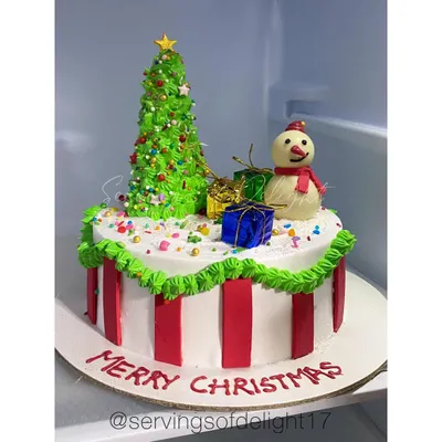 My Merry Christmas cake. This festive creation features a buttercream Christmas tree, a cute snowman, and edible presents.