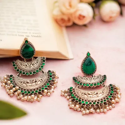 The rich texture of oxidized silver and the pop of emerald green in these earrings asked for a soft, romantic setup. I paired them with a blush backdrop and an open book to hint at quiet luxury and timeless charm.