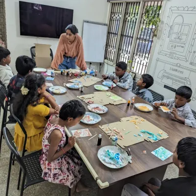 A facilitator guiding a group of kids through a marble art experiment during a field trip at our lab.