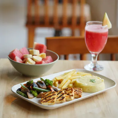 A perfect brunch spread to start your Sunday right. Our grilled paneer platter comes with sautéed veggies, mashed potatoes, fries, and a fresh fruit bowl. It's a wholesome meal to fuel your day.