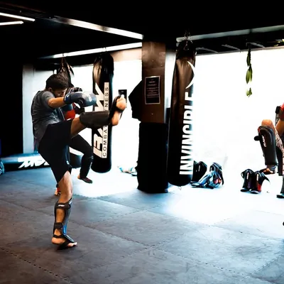 A group of young fighters practicing their kicks in a synchronized drill. Repetition is the mother of skill, and here we build muscle memory for powerful and accurate strikes.