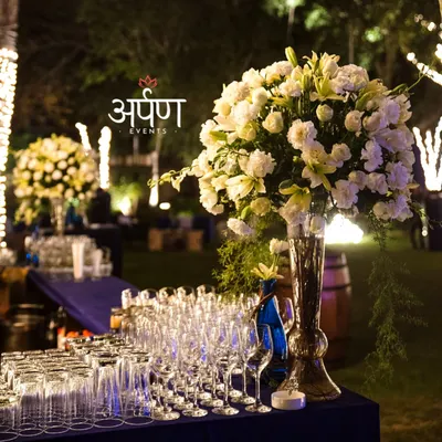 A close-up of a fully stocked and beautifully decorated bar for a large outdoor event. I provide a wide selection of high-quality glassware for wine, cocktails, and other beverages, ensuring every drink is served perfectly.