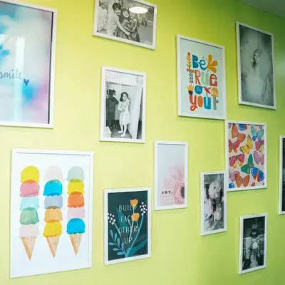 Our "Wall of Joy" is filled with colorful art and happy photos, reflecting the warm and cheerful atmosphere of our play cafe.