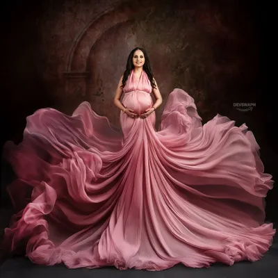 A dramatic portrait featuring a beautiful dusty rose gown with an incredible flowing train. I use fabric tossing techniques to create this sense of movement and grandeur against a painterly, textured backdrop.