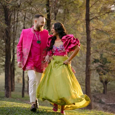 Ben and Shrutika, walking through a sun-dappled forest. Their vibrant outfits and shared laughter create a portrait that is full of life and movement, a perfect reflection of their joyful connection.