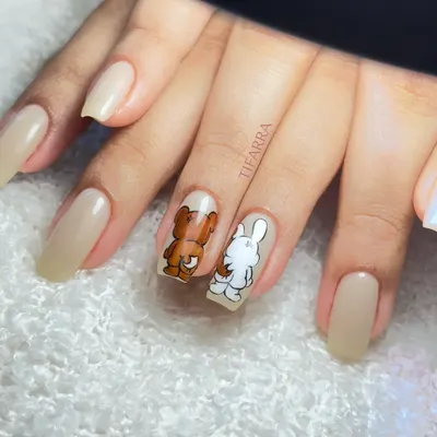 Me and my bestie trying to coordinate. This cute set on long square extensions features hand-painted characters on a simple nude base.