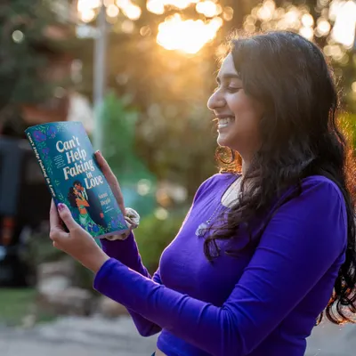 She's here. My second romance novel, *Can't Help Faking in Love*, is out now in the US and Canada. This photo was taken on release day, and I'm so happy to finally share this story with you.