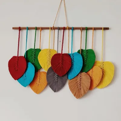 This custom macrame leaf wall hanging features a rainbow of vibrant colors. It's a beautiful and cheerful piece that can brighten up any room.