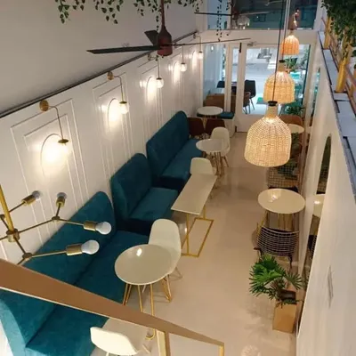 This top-down perspective reveals the complete layout of a modern cafe we designed. Notice how the long banquette seating maximizes space along one wall, while varied table arrangements create distinct zones for different group sizes.