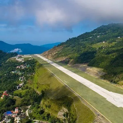An aerial perspective of the Pakyong Airport runway, showing its integration into the mountainous landscape of Sikkim. This project was a massive "cut and fill" operation, a true feat of geotechnical engineering designed to provide vital national connectivity.