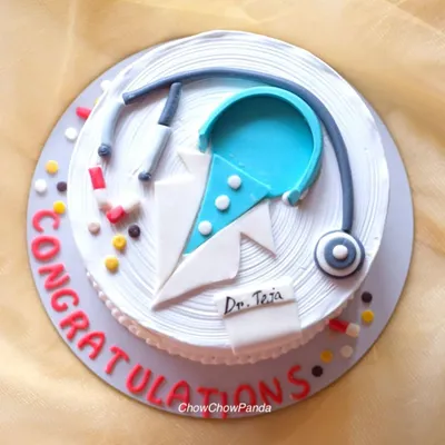 A top-down view of the doctor-themed cake, showing the handcrafted stethoscope, pills, and doctor's coat details. This was a Truffle with Ferrero Rocher cake.